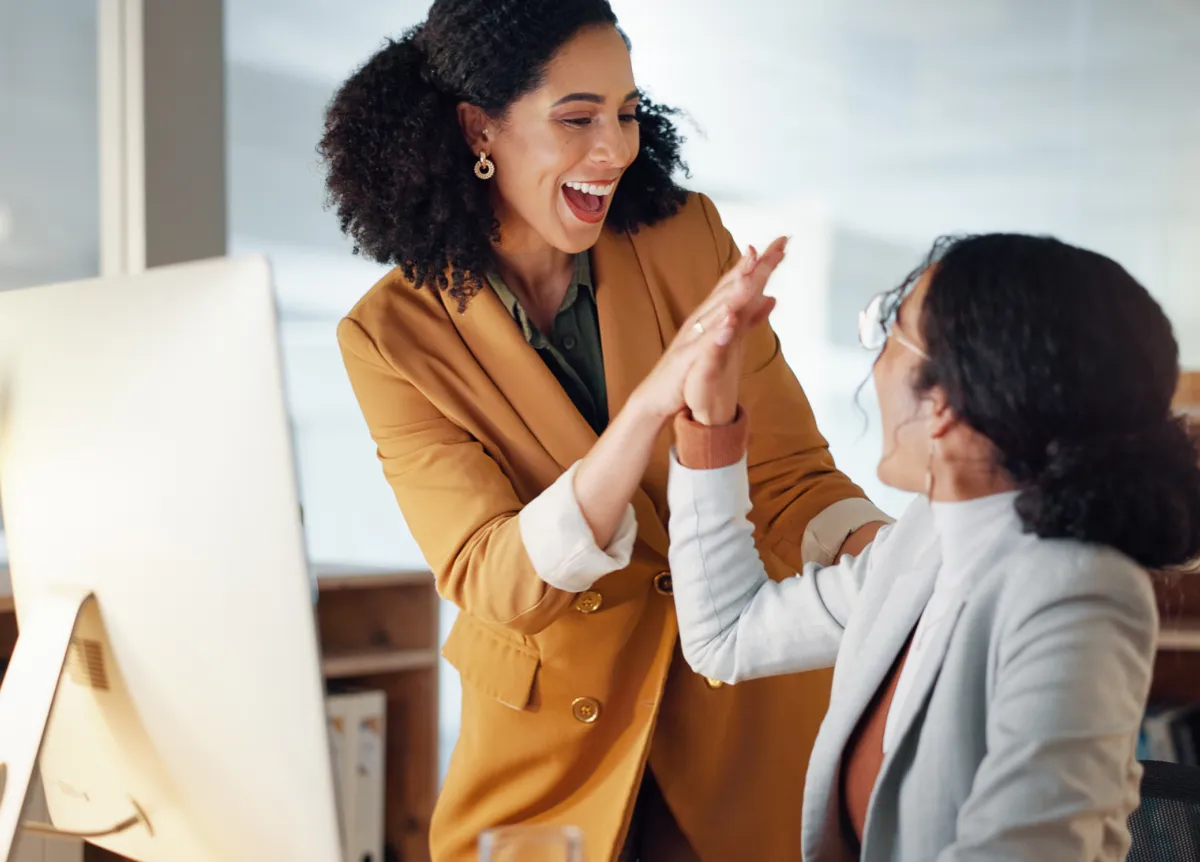 Businesswomen high-fiving