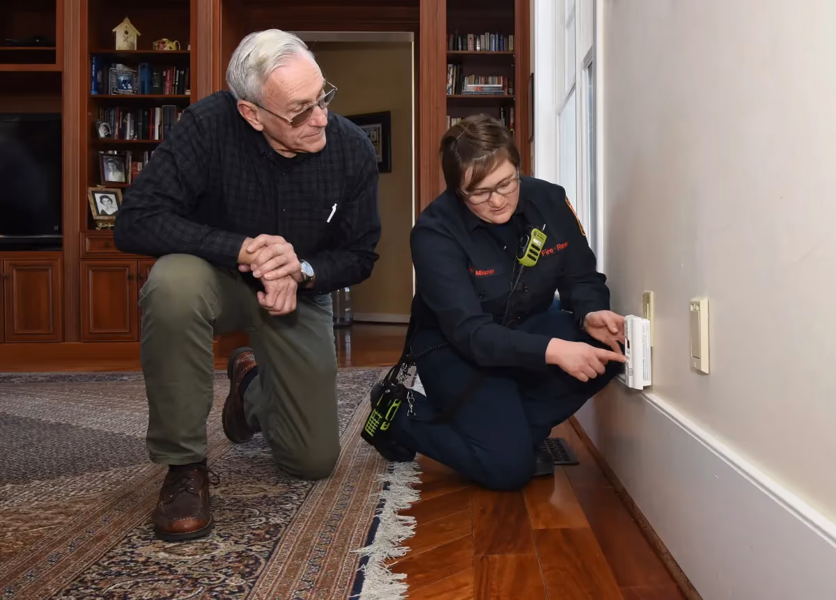 Person installing a carbon monoxide alarm
