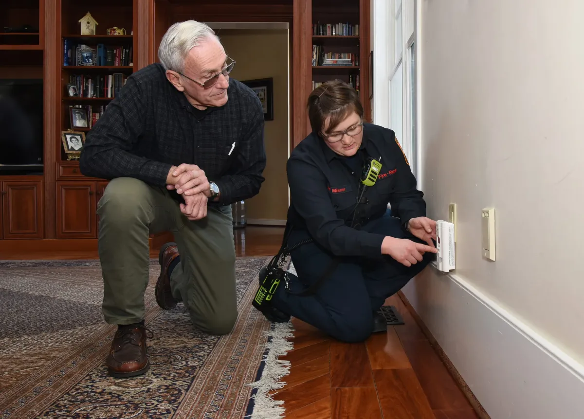 Person installing a carbon monoxide alarm