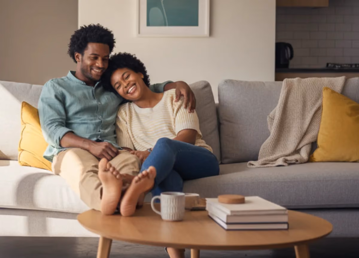 Couple sits together on couch