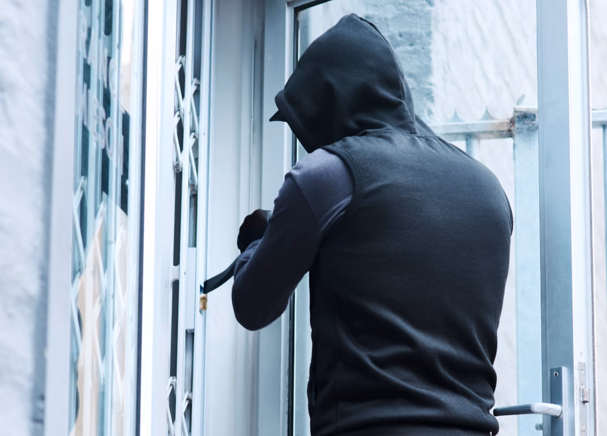 Hooded man breaking into house