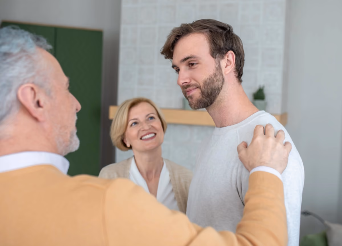 Man standing with older parents