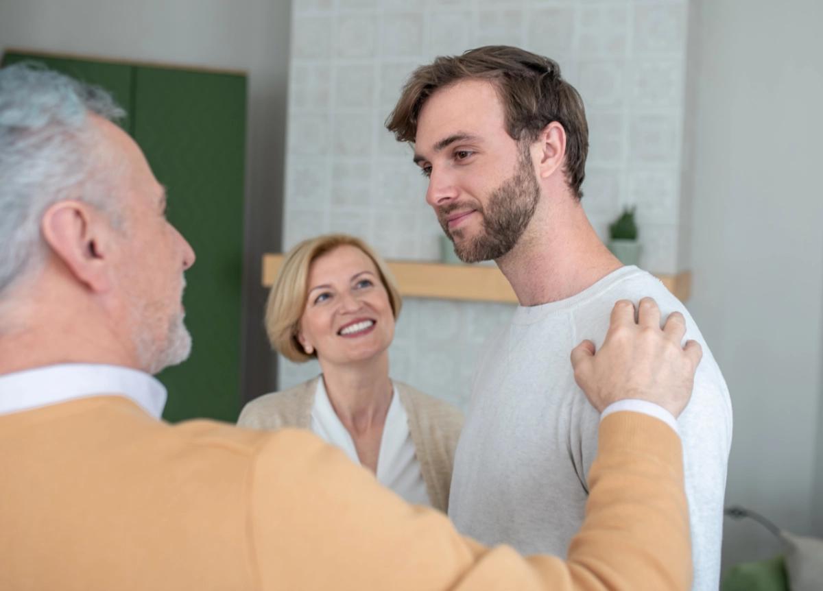 Man standing with older parents