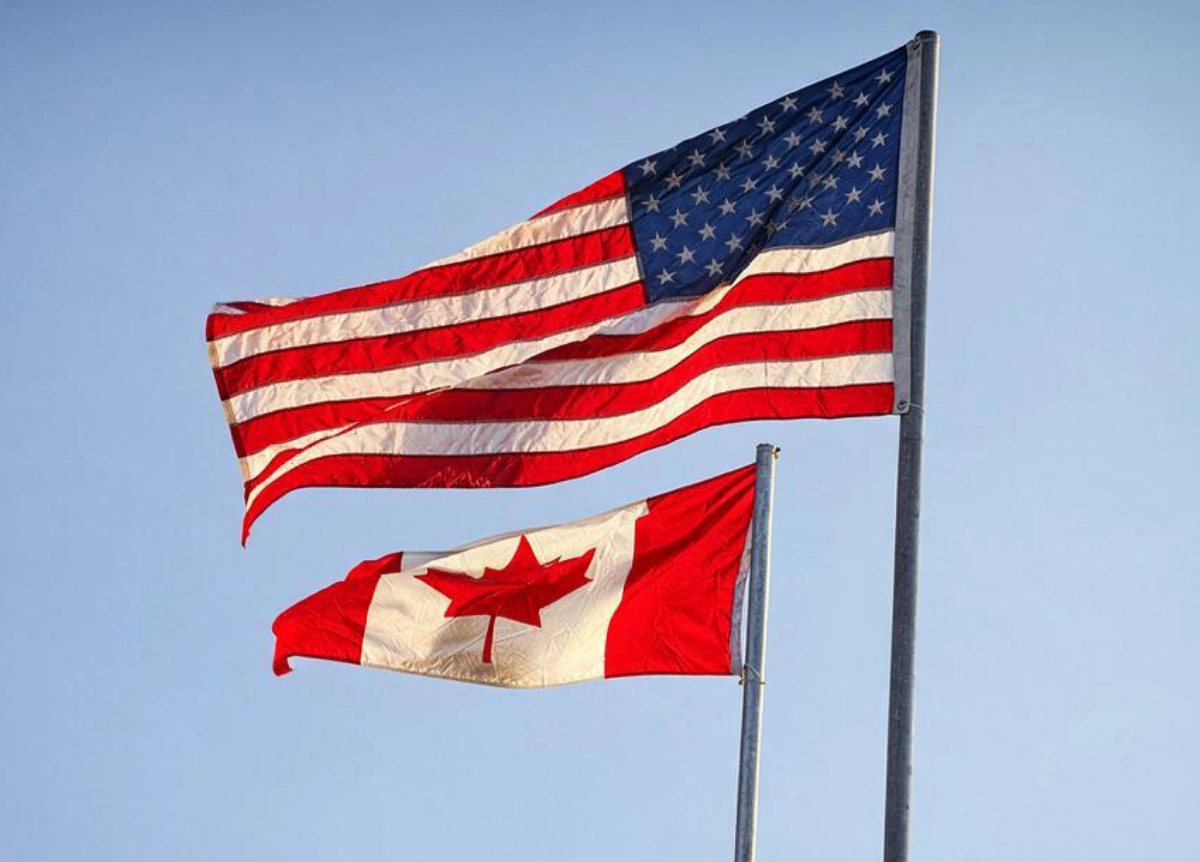 Canadian and US flagpoles side-by-side