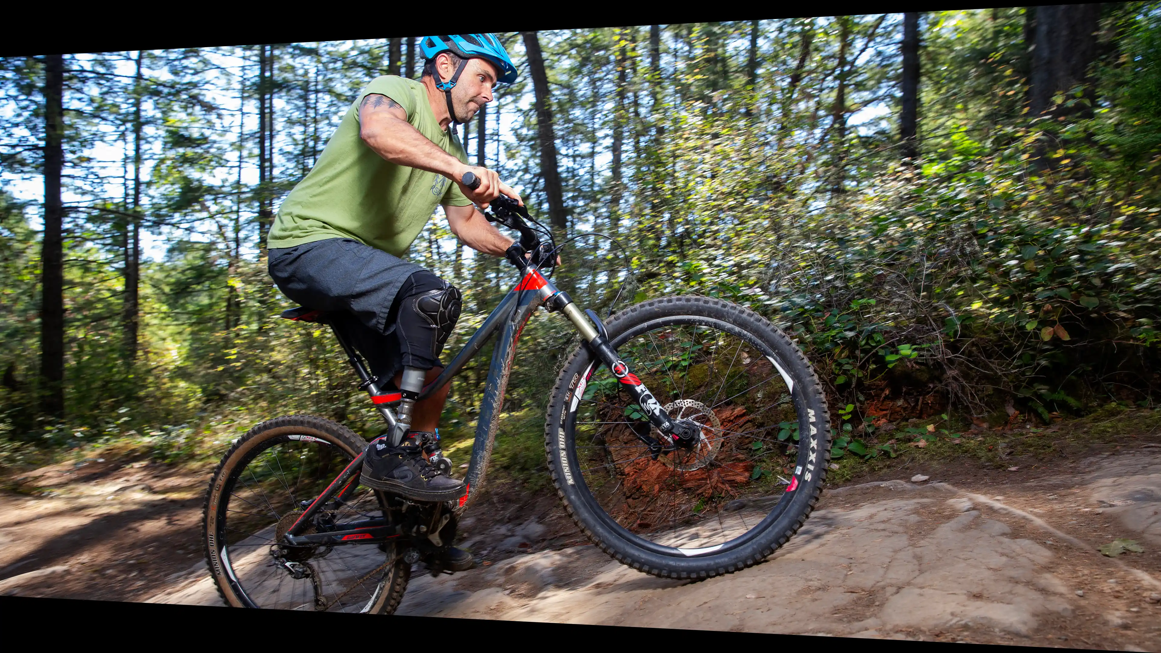 A CanAssist client riding a mountain bike uphill using CanAssist assistive technology