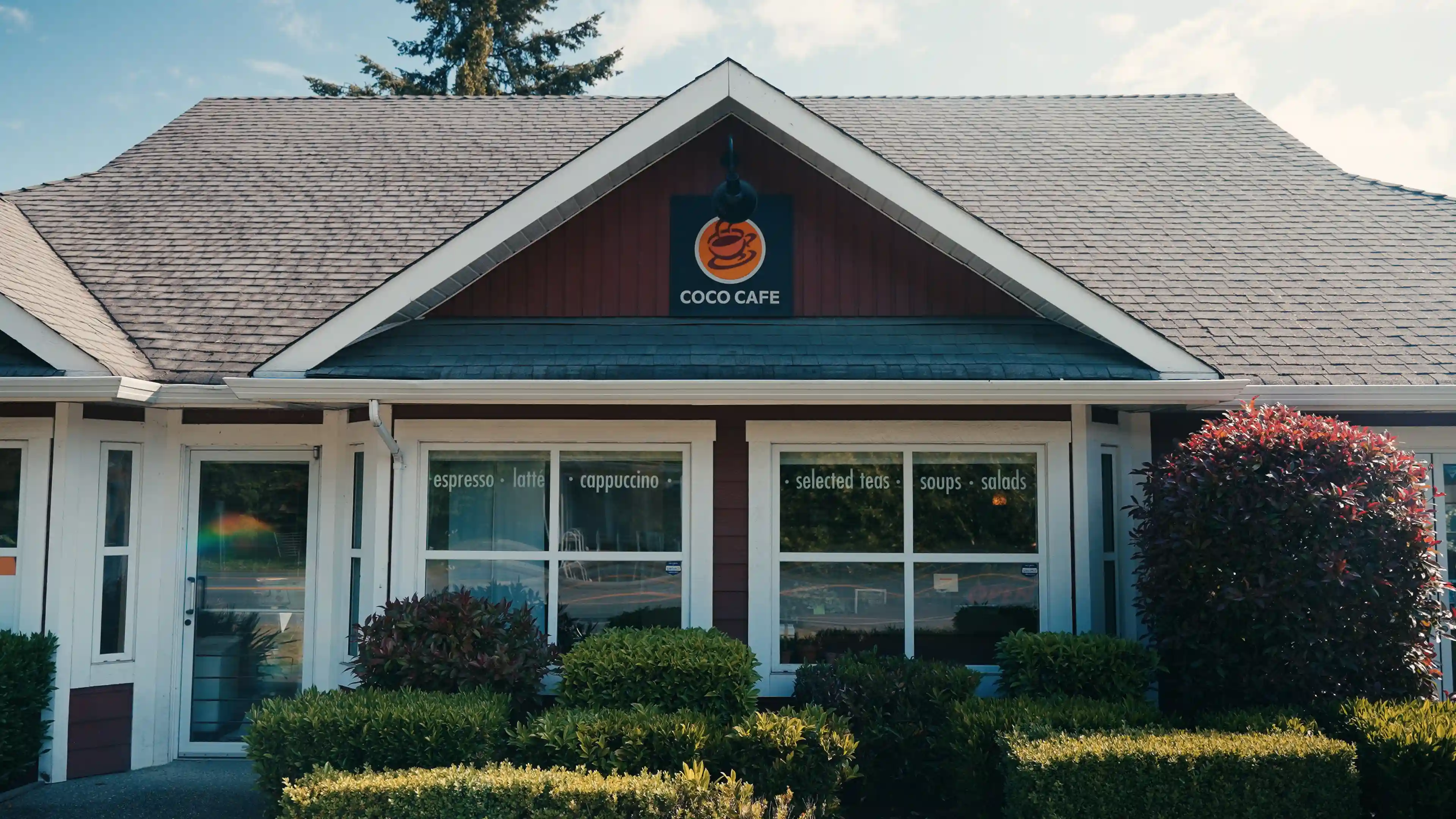 The charming exterior of Coco Cafe with greenery