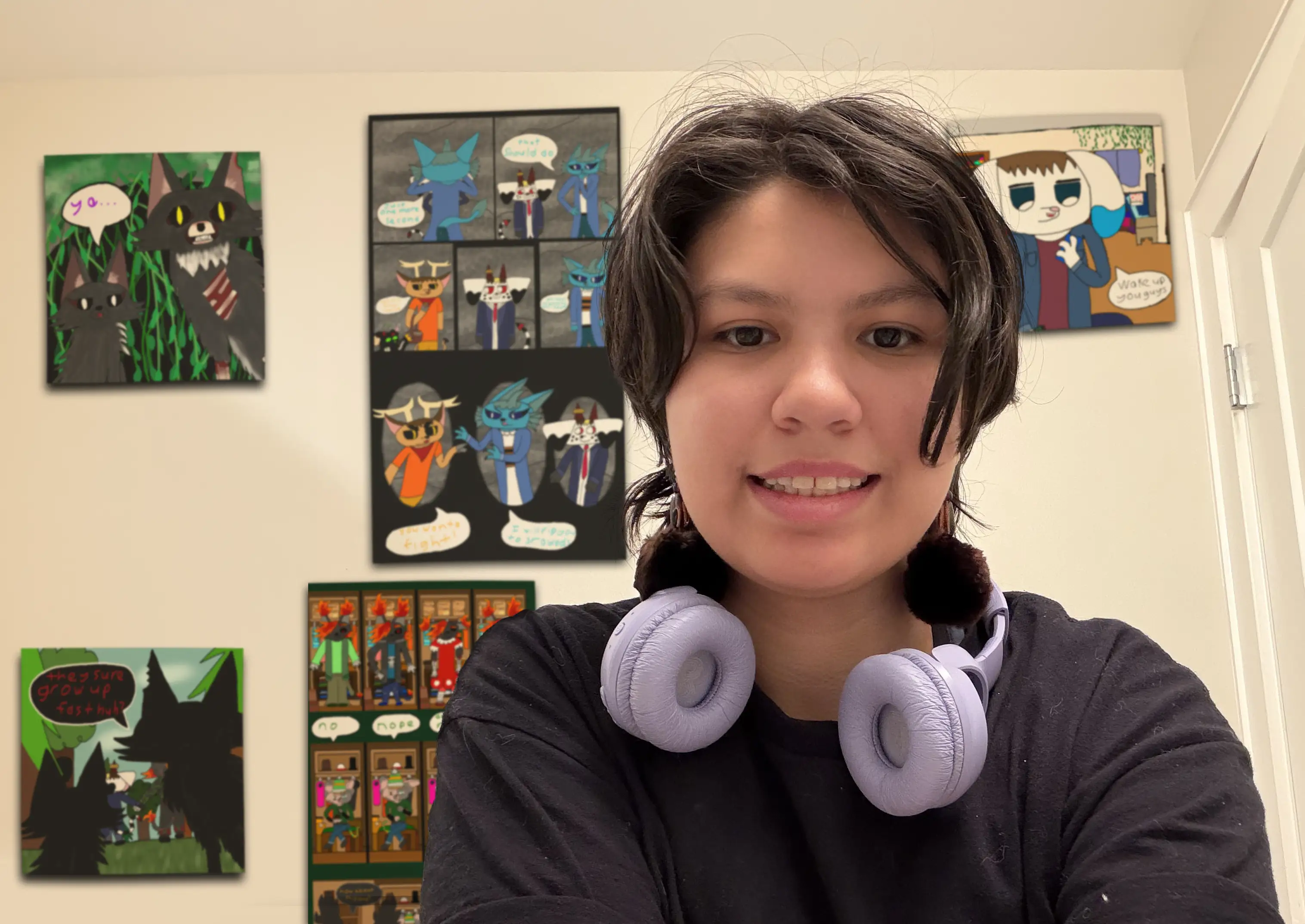 Artist wearing headphones standing in front of wall with comics and storyboards