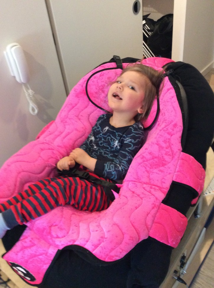 A CanAssist client smiling using the pedal-assisted guitar strummer assistive technology