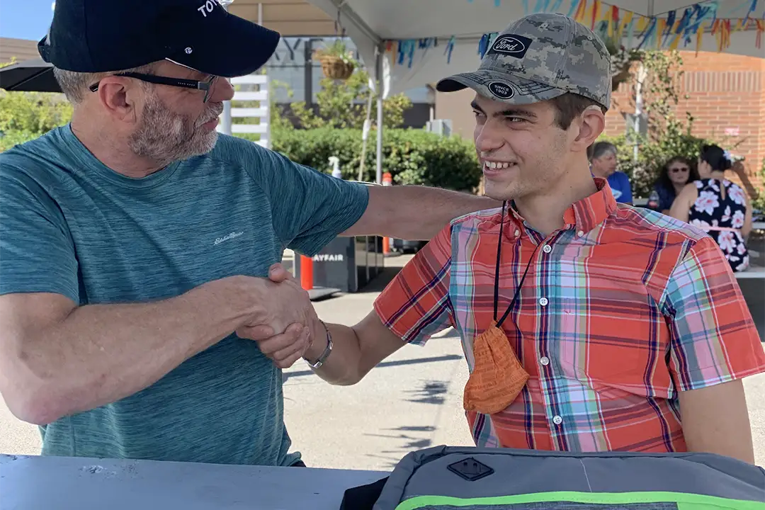 A father and son shaking hands