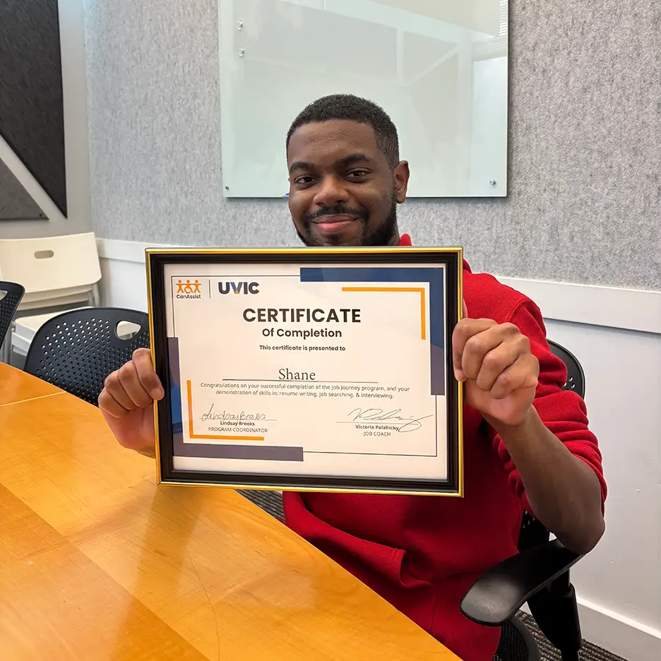 A Job Journey participant holding up CanAssist Certificate of Completion