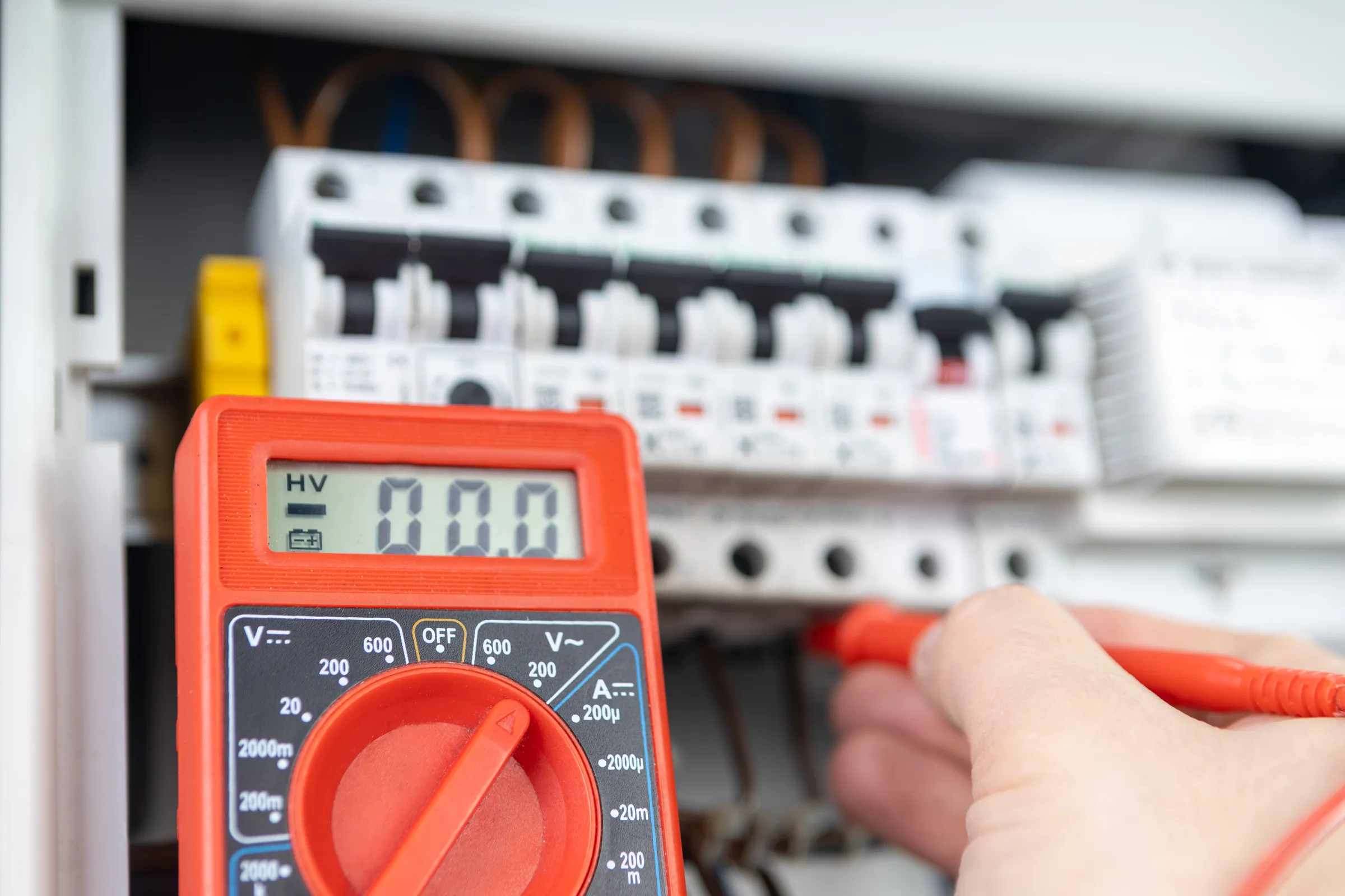 Electrician working on residential wiring background