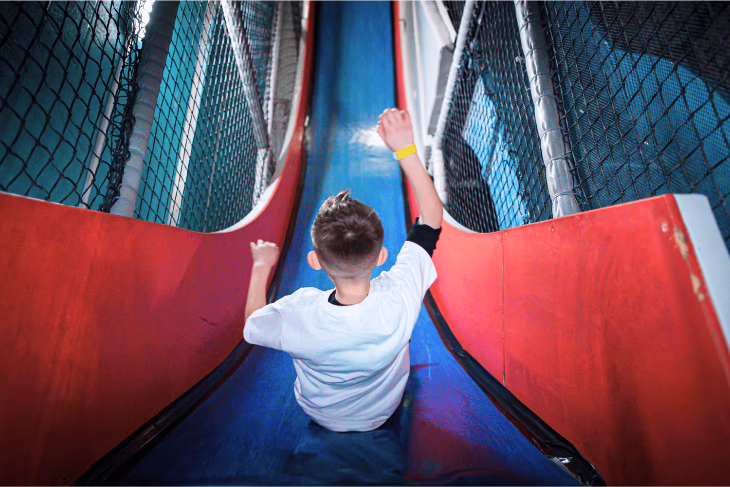 A child about to slide down a drop slide. 
