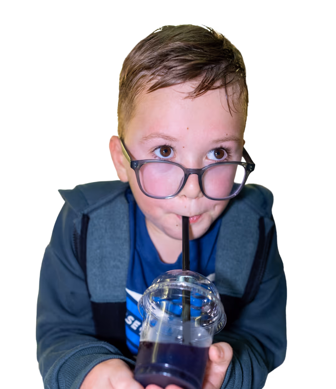 A child drinking a slush looking excited 