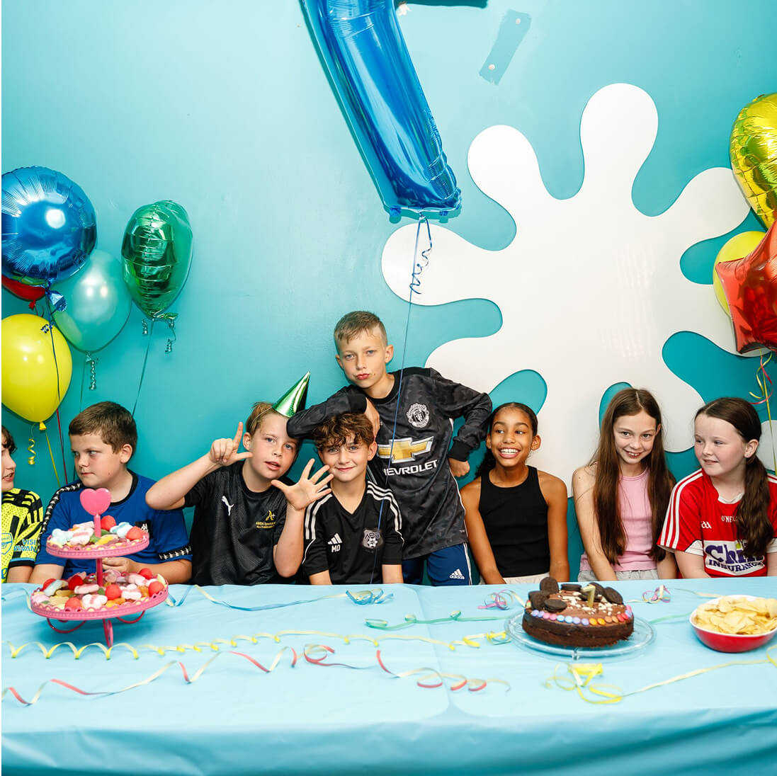 Children's birthday party with cake, balloons, and colorful festive decorations