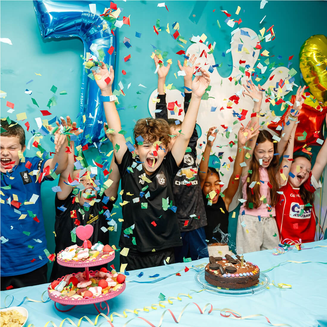 Kids celebrating with confetti, balloons, and birthday cakes
