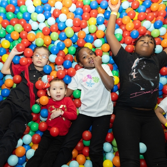 Children playing and having fun in a colorful ball pit