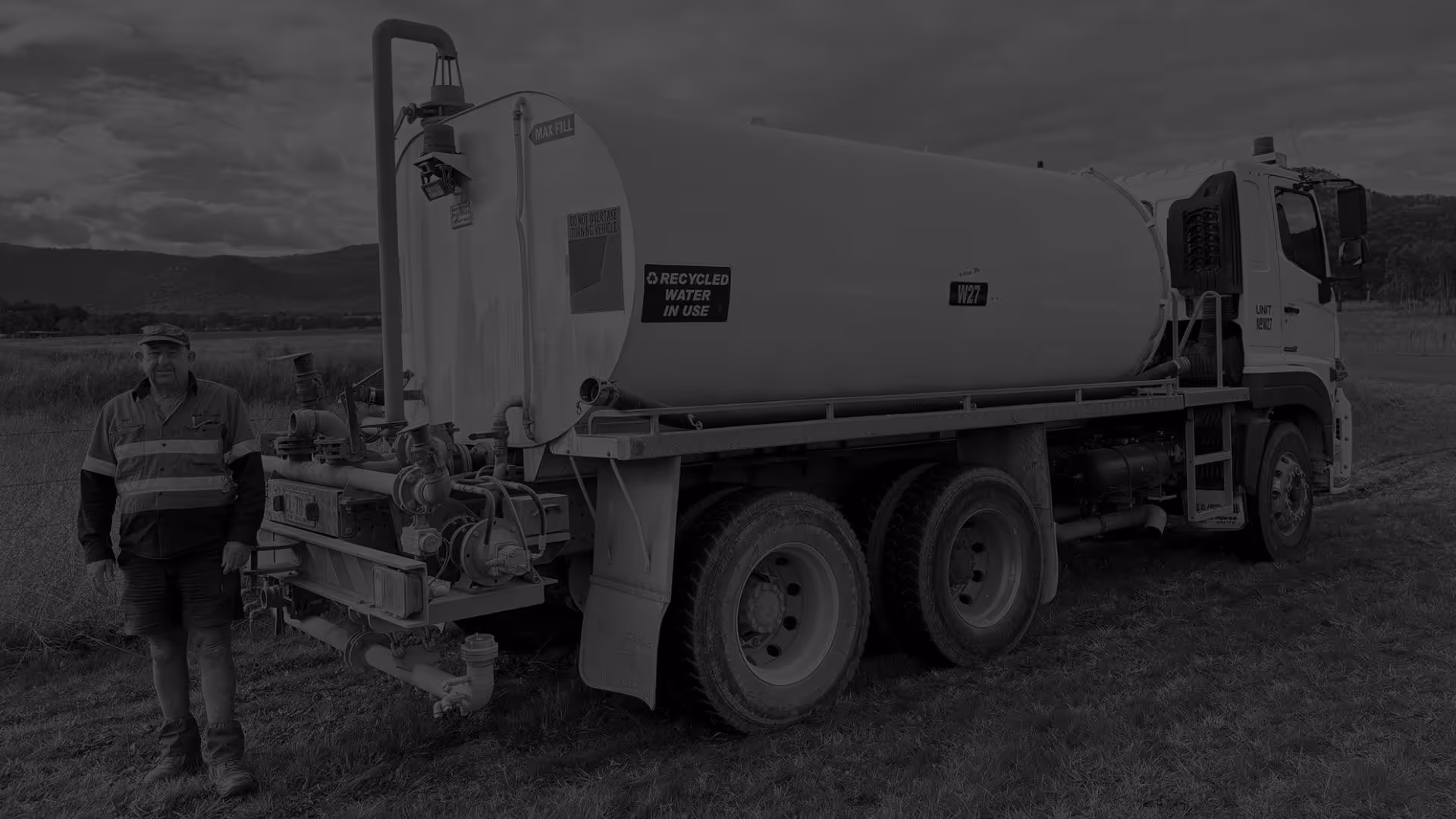 Man standing in front of water truck