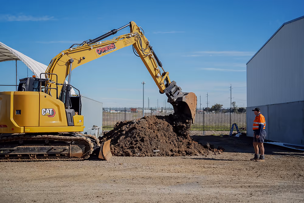 Large yellow Cat excavator picking up dirt
