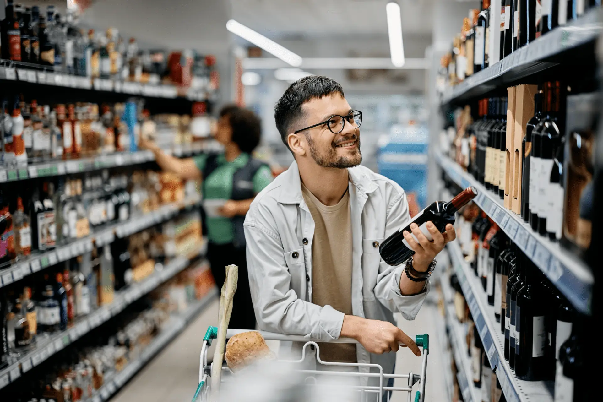 Man in a liquor store looking at wine.