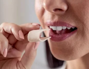 Woman putting gum in her mouth