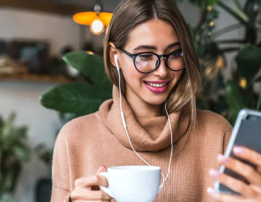 Woman on phone with a coffee