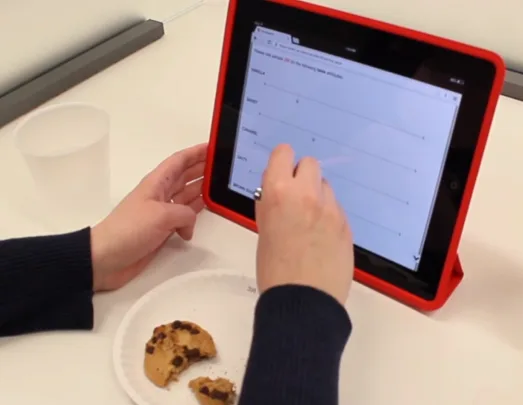Subject with a cookie responding to questions on a tablet