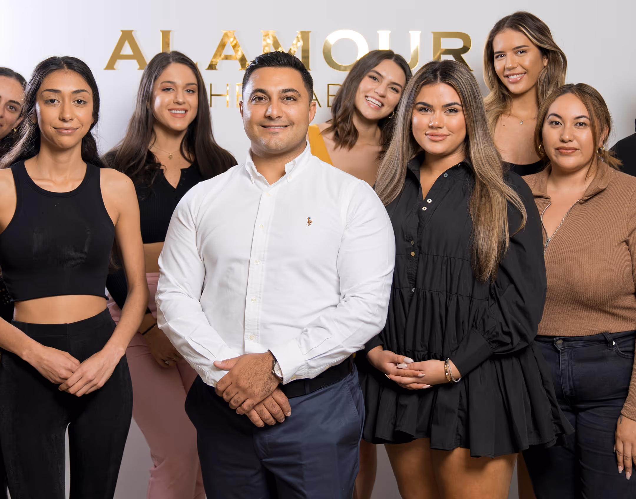 A group photo of women with the office man.