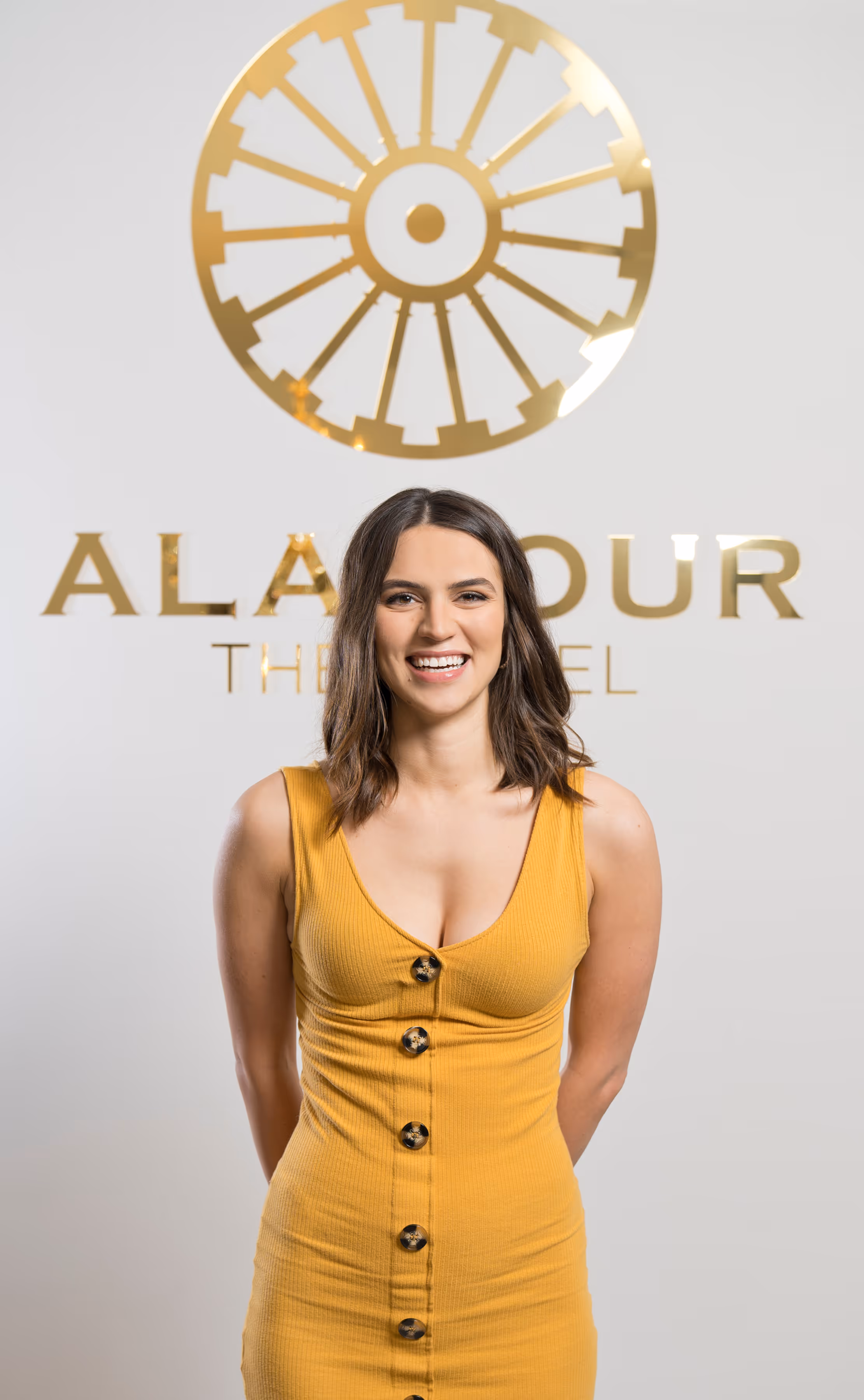 A smiling photo of women wearing the yellow dress.
