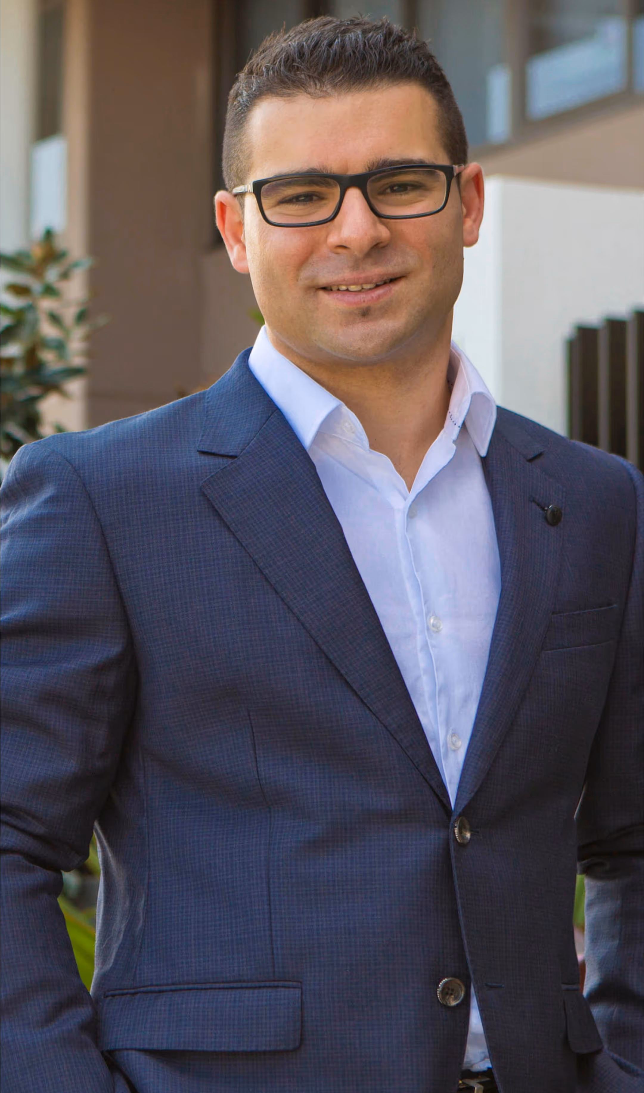 A smiling photo of a man while wearing the beautiful black coat. 