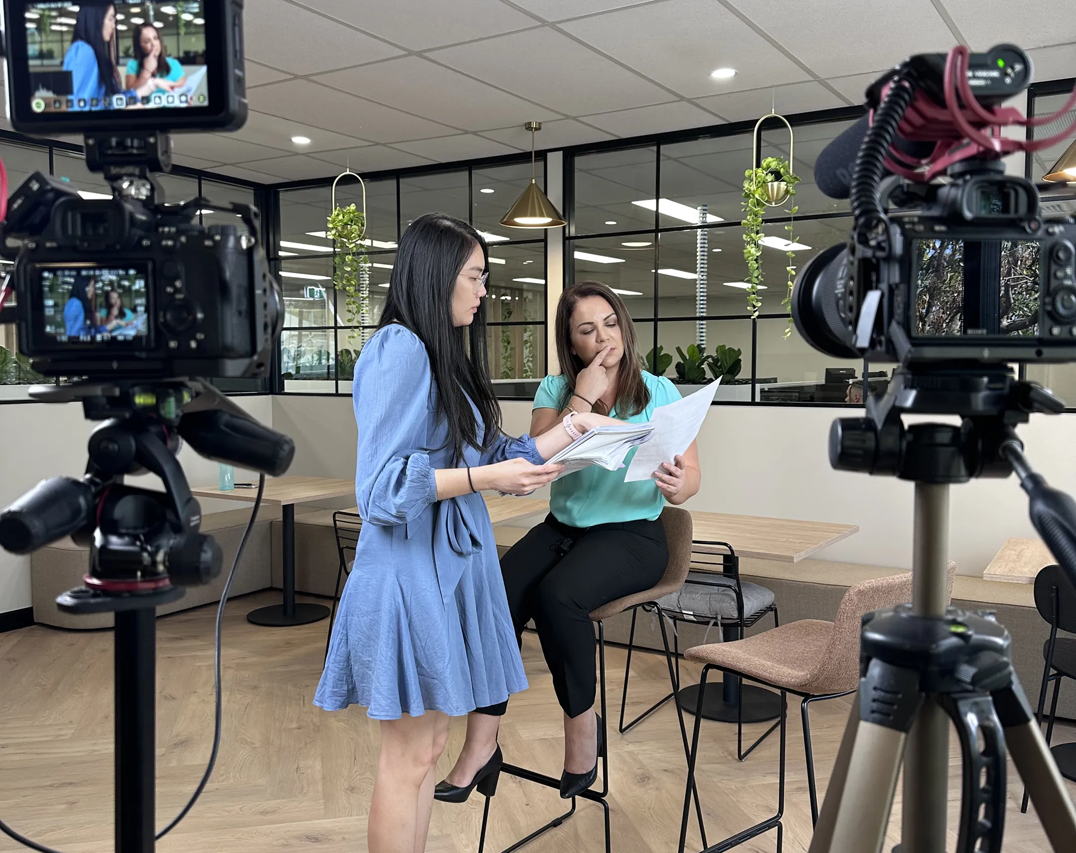 Female director leading a commercial videography team during an on-site production.