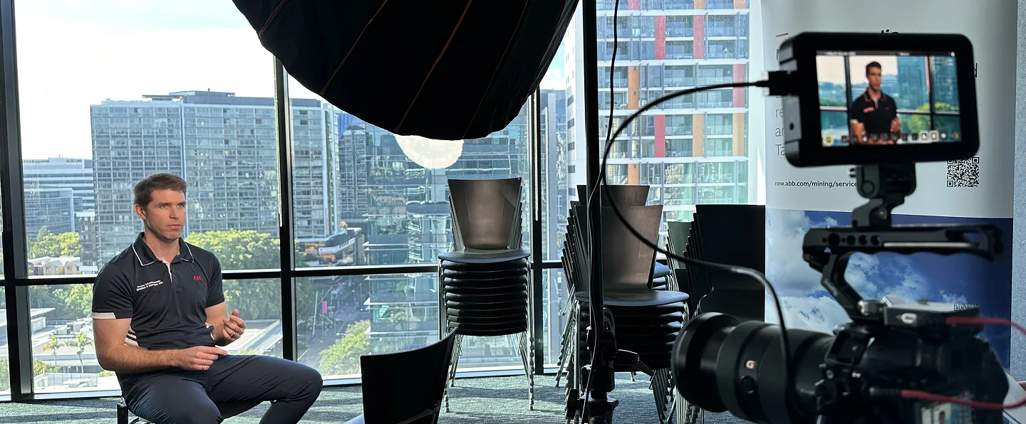 The man sitting in the video shooting room, shooting the video.