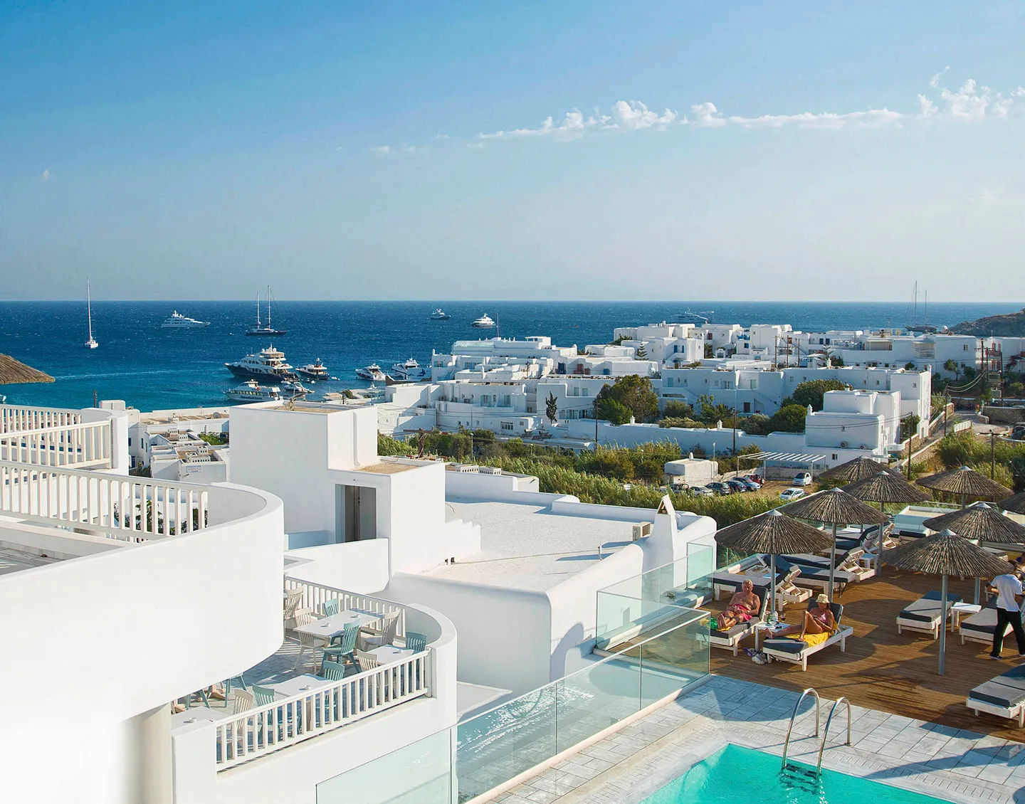 A Beautiful view of a sea from the top of it while people are enjoying there.