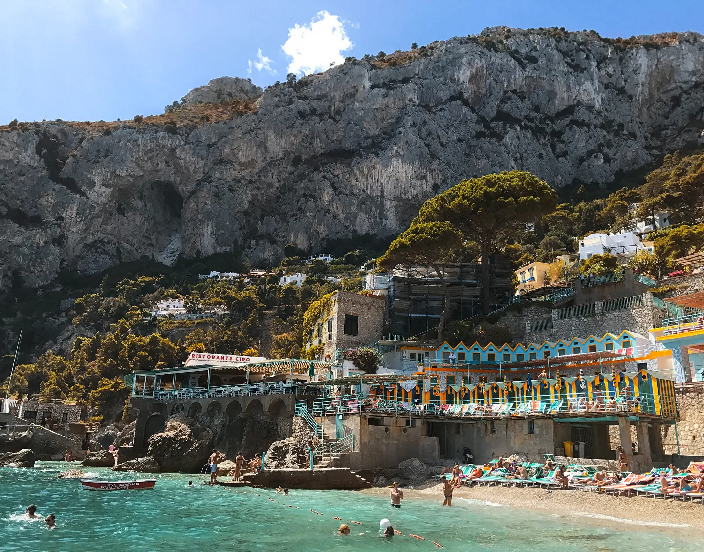 A Beautiful view of a sea from the top of it while people are enjoying there.