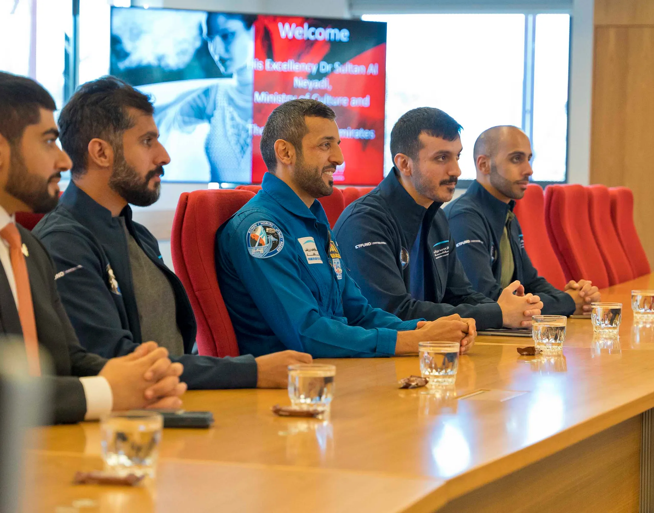 A group of colleagues conducting a meeting in a conference hall.
