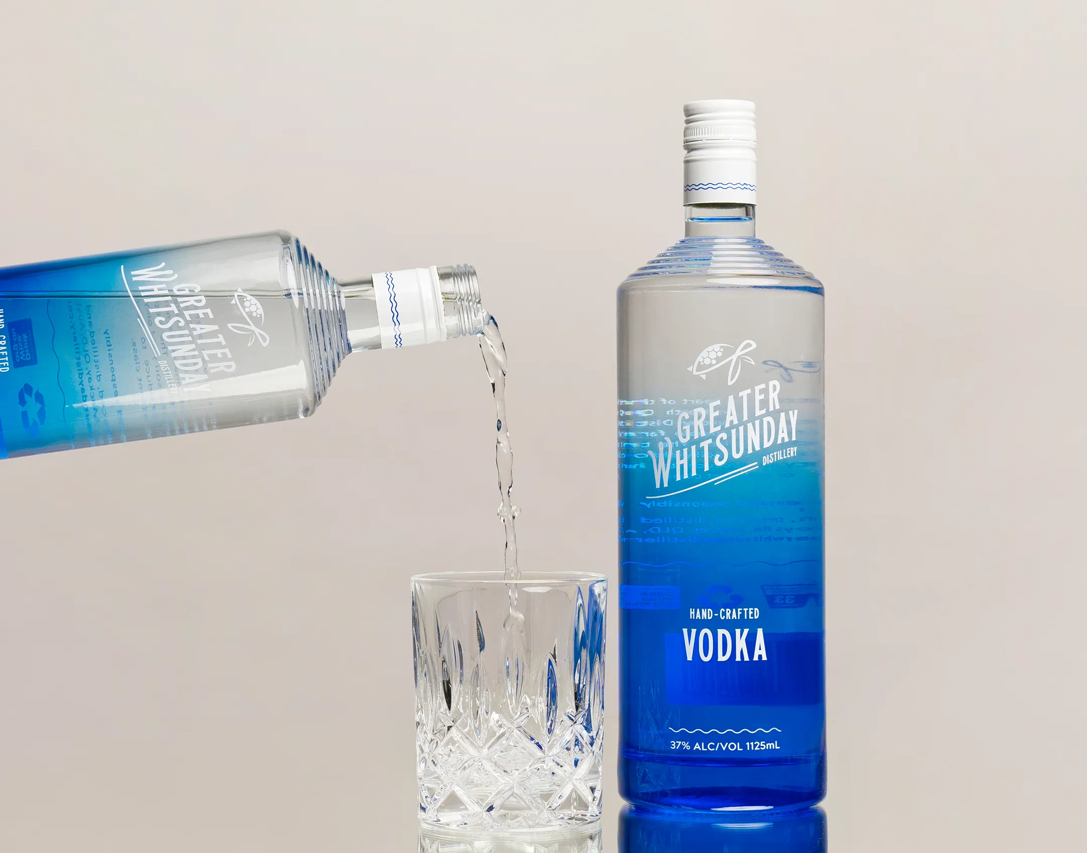 A bottle of VODKA water being poured into a glass.