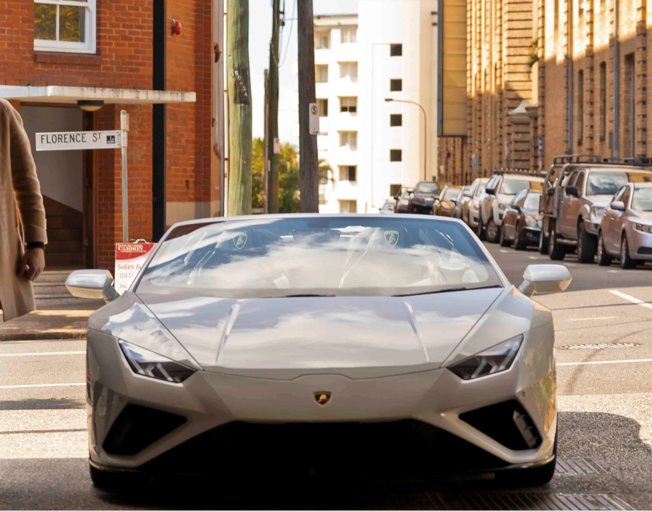 A Beautiful car standing on a city street.
