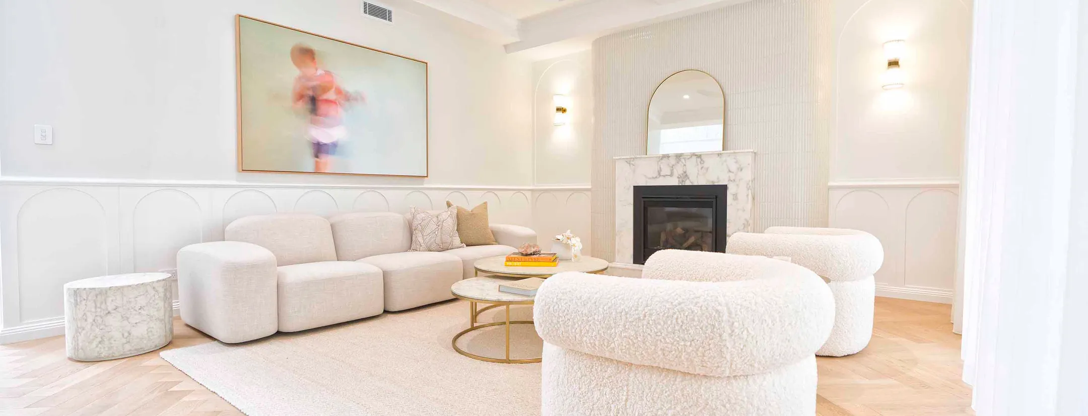 A beautifull room photo from the inside of it while there are kept beautifull sofas.