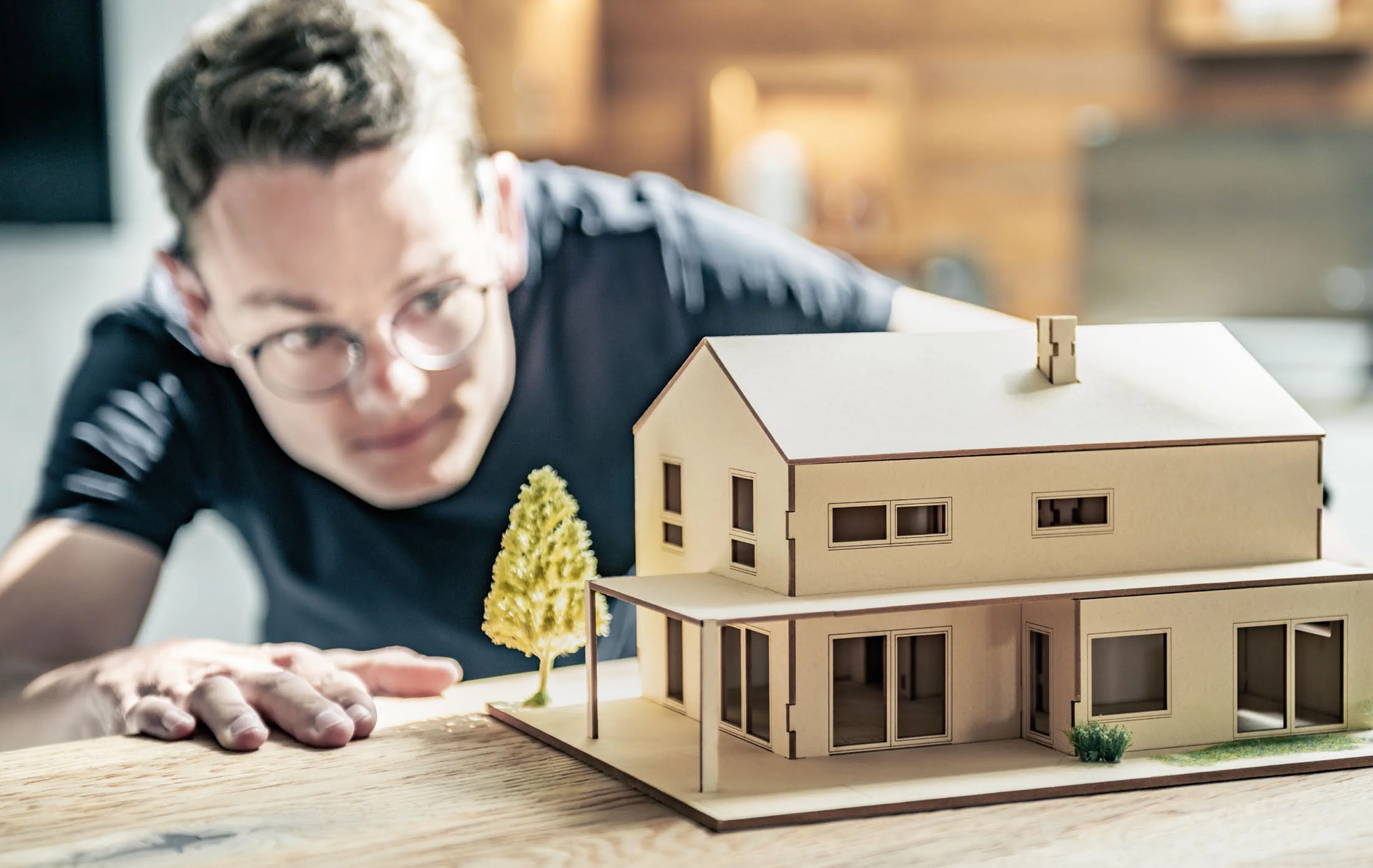 Interessent betrachtet Hausmodell von HAUSER Massivbau.