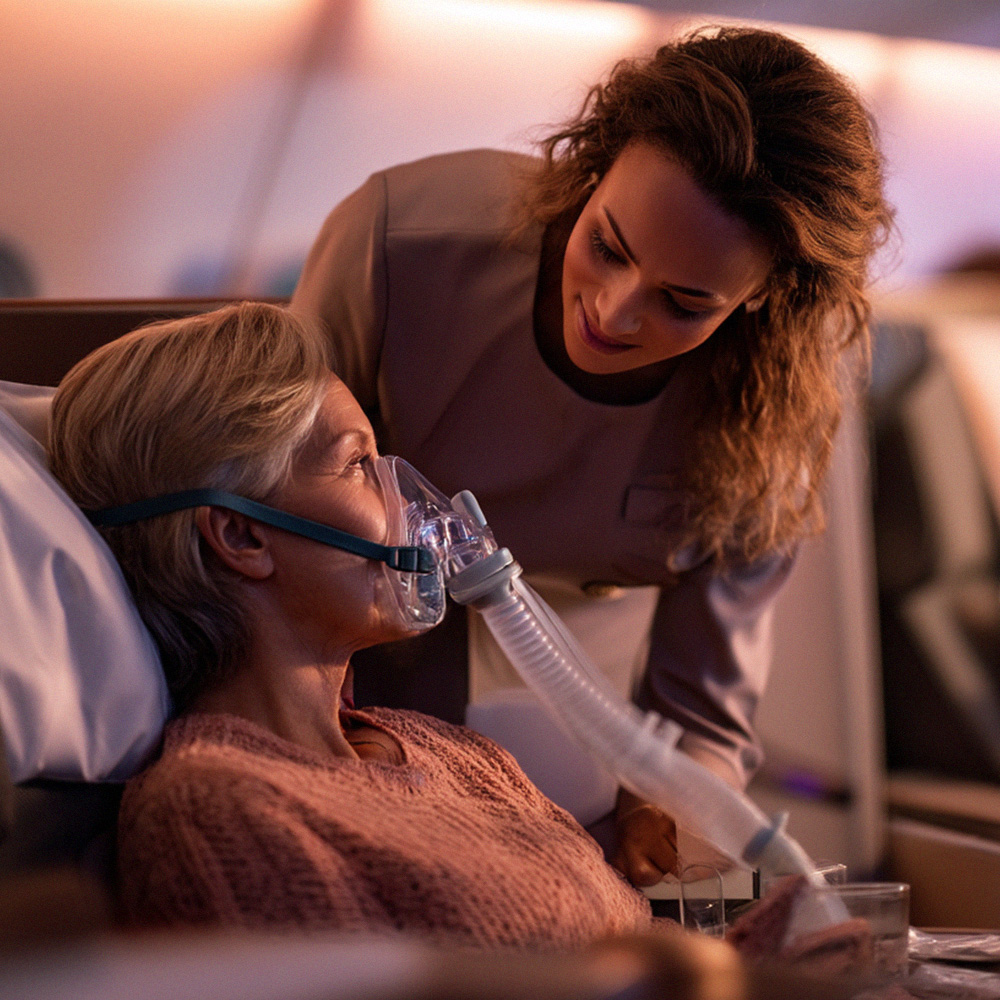 A woman in a hospital bed with an oxygen mask on.
