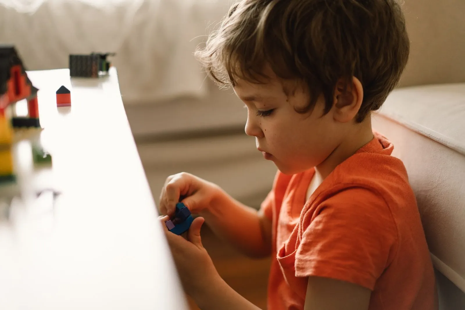 child playing with blocks at desk