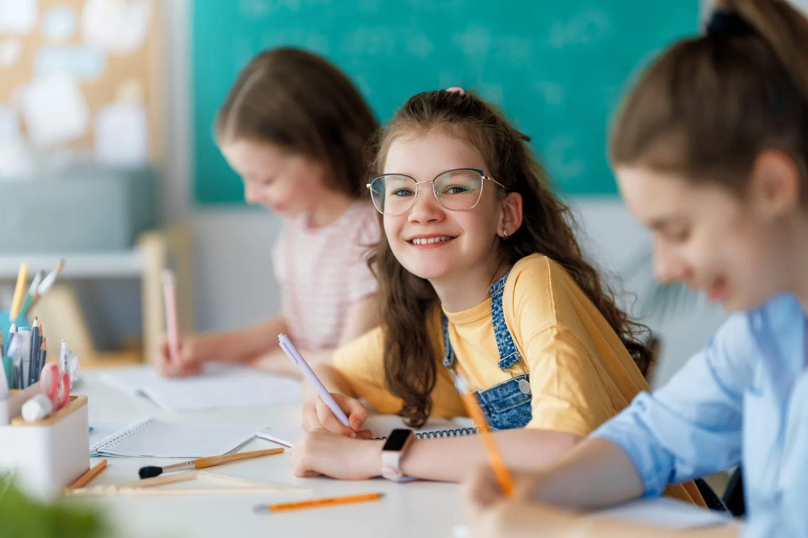 smiling girl in class with peers