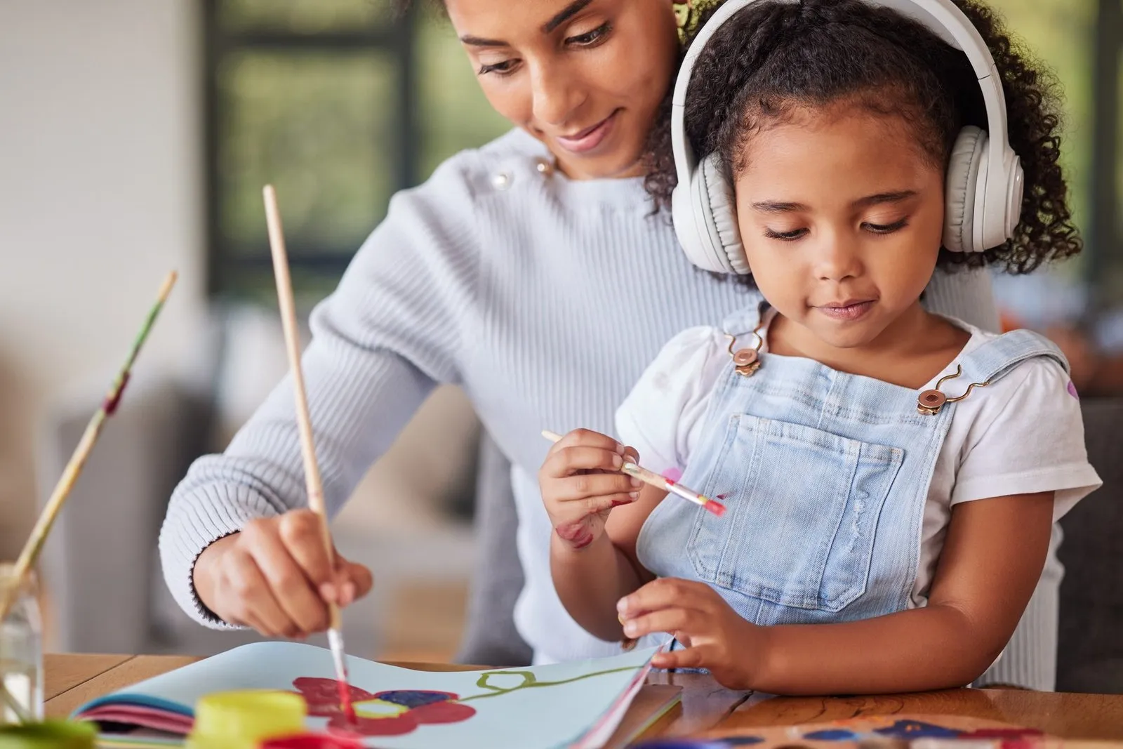 a woman and a child painting