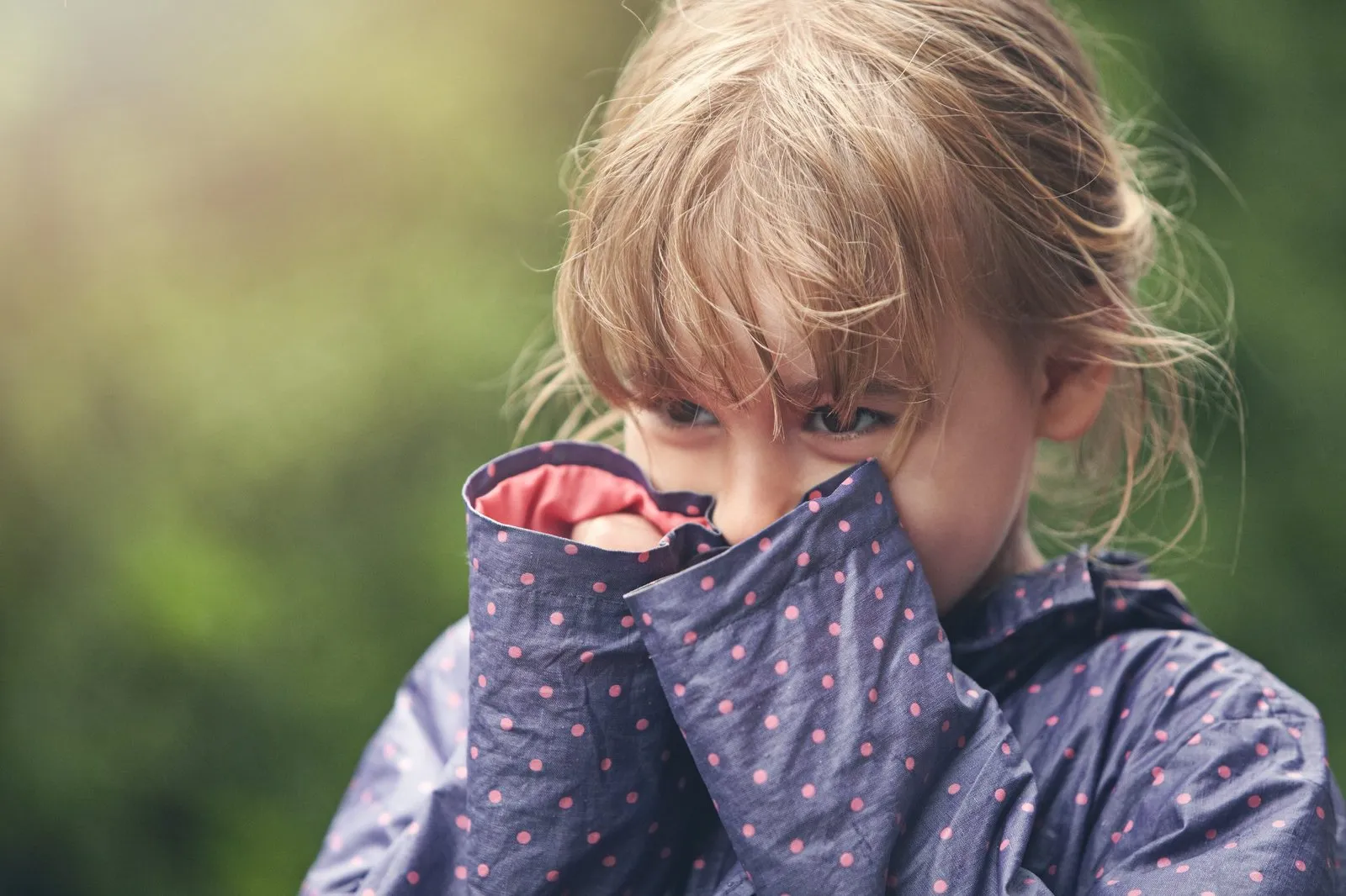 a girl covering her face with her hands