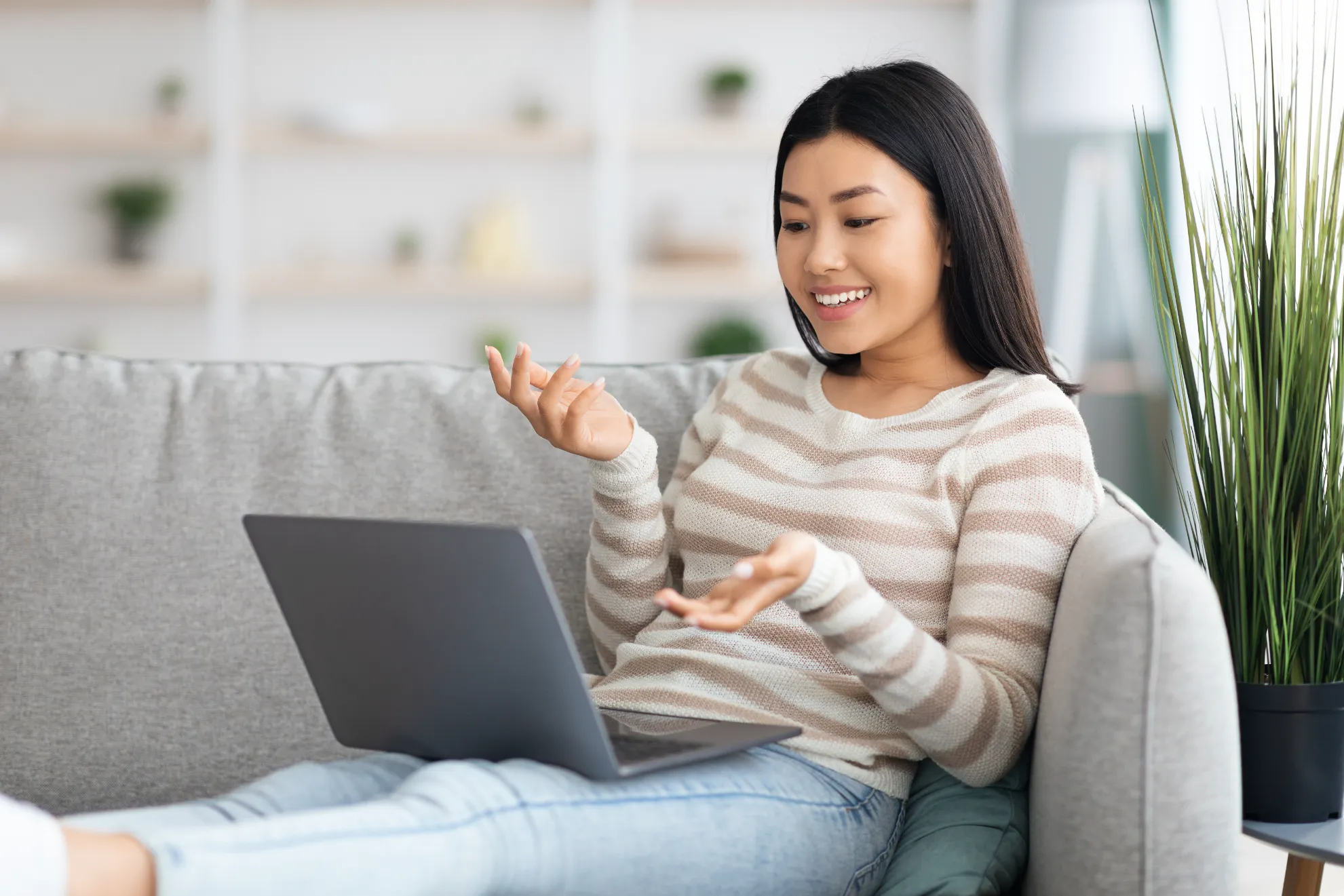 a woman sitting on a couch using a laptop