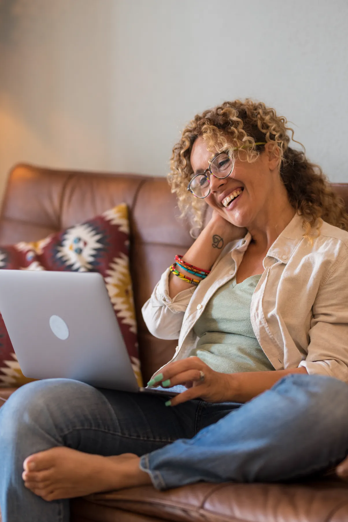 a woman sitting on a couch with a laptop