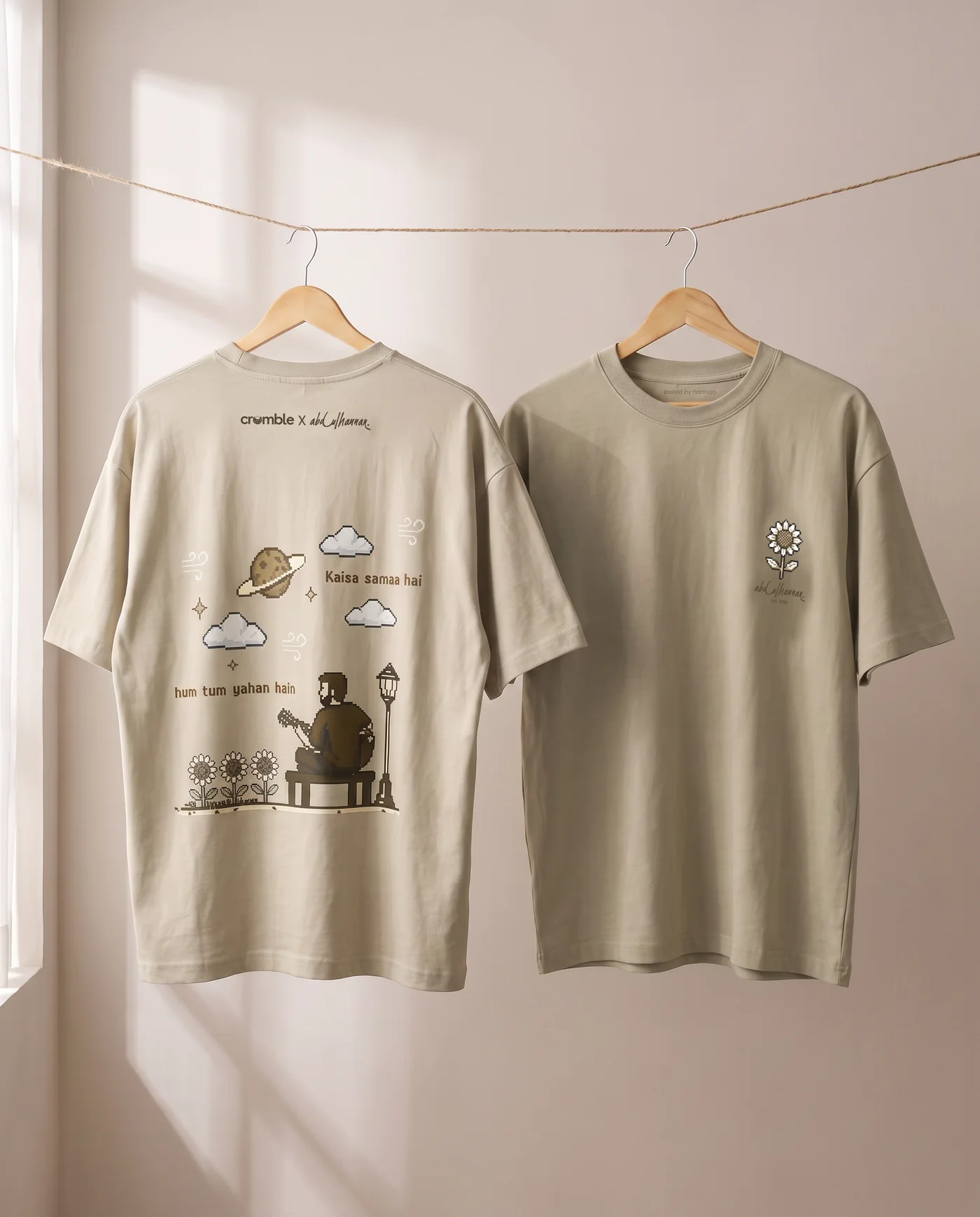 The Bench Tee on a line — back print with the bench scene, and the front with its chest sunflower