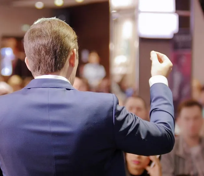 A man standing in front of a crowd of people.
