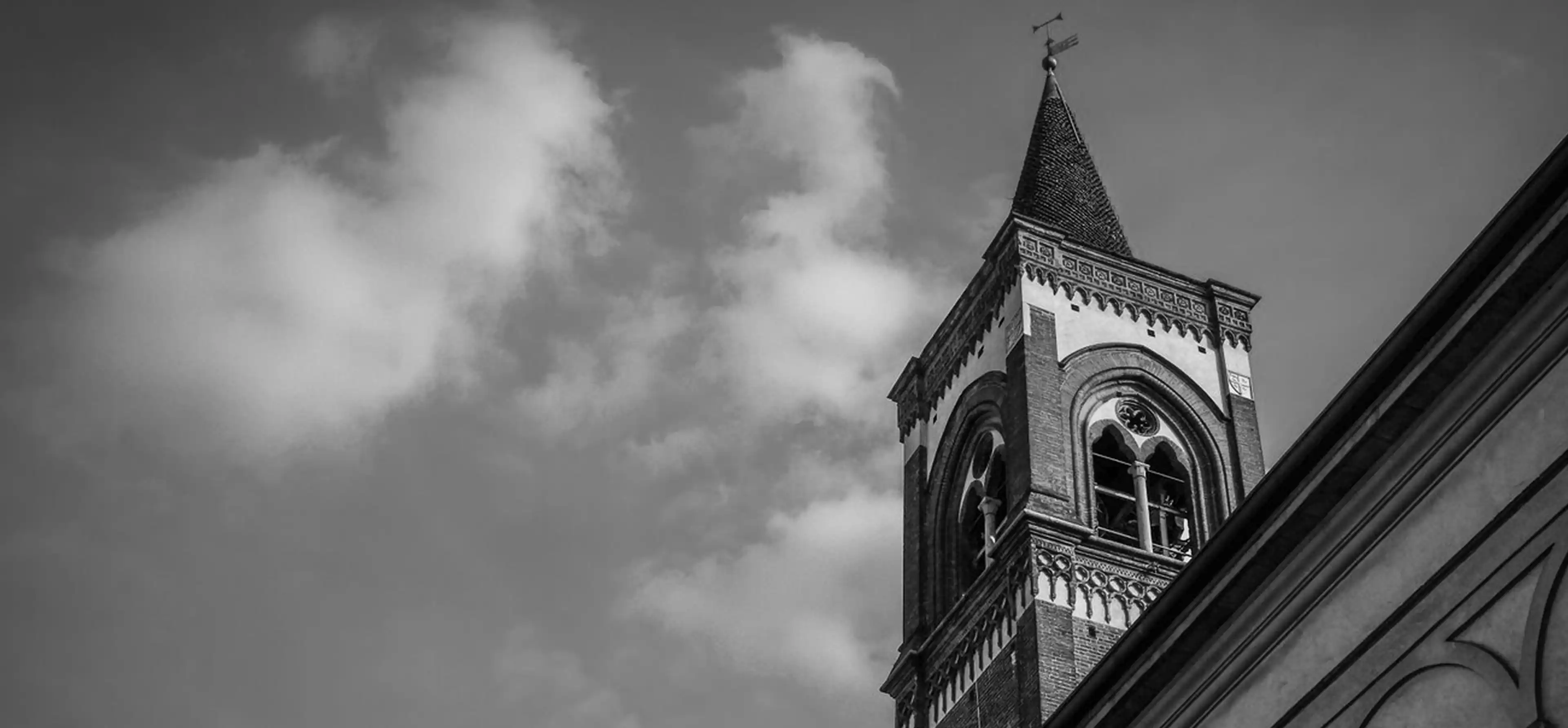 A black and white photo of a church steeple.