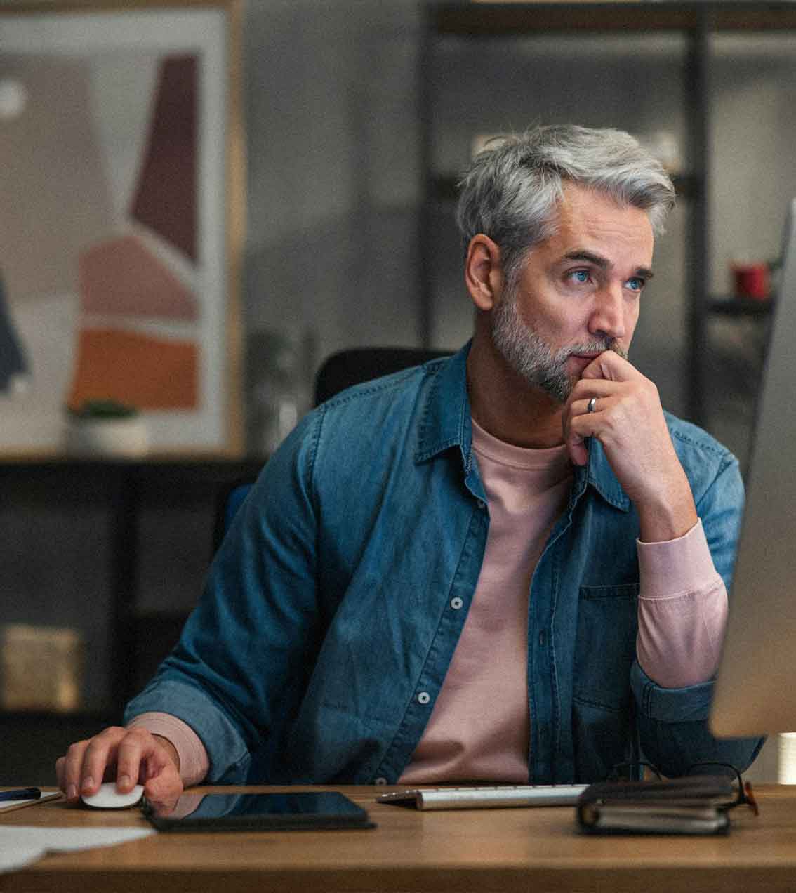 A man sitting in front of a laptop computer.