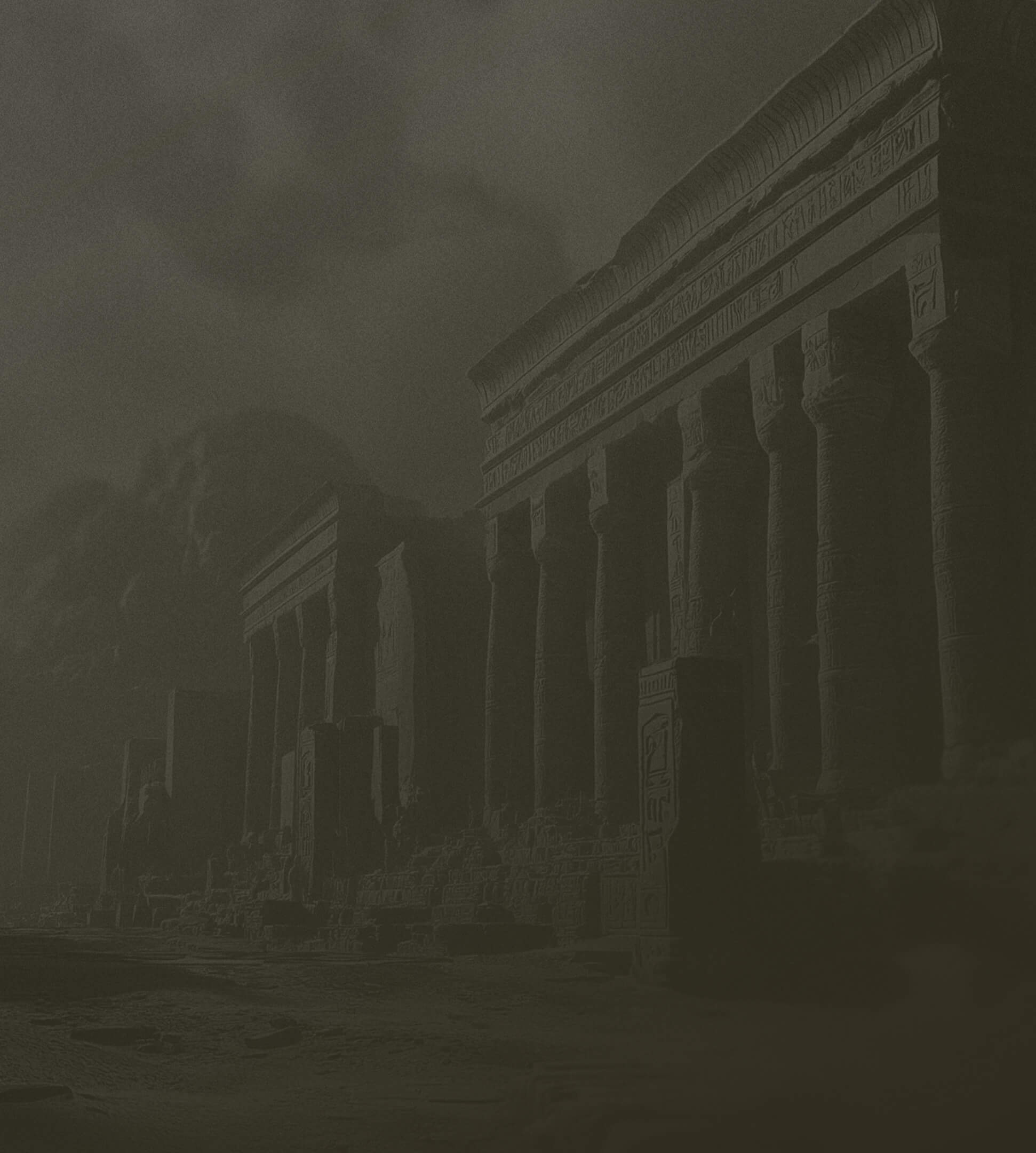 Ancient Egyptian temple ruins with tall columns inscribed with hieroglyphs under a dark, cloudy sky.